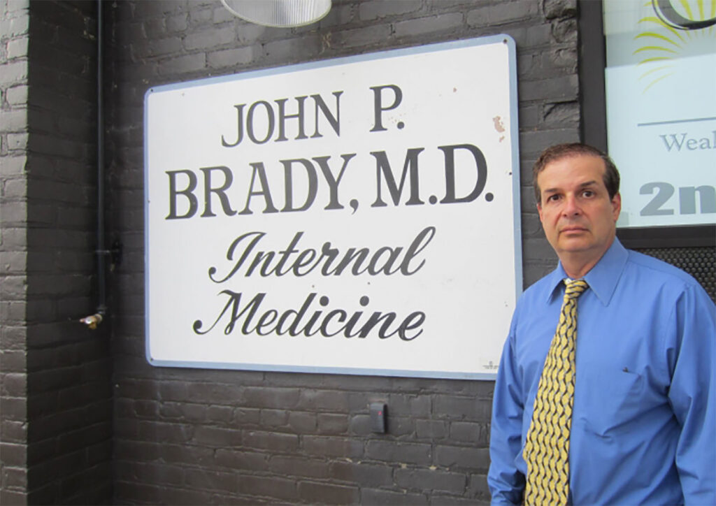 Dr. Brady standing in front of his internal medicine practice